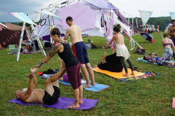 Debby leads acro yoga at retreats and festivals