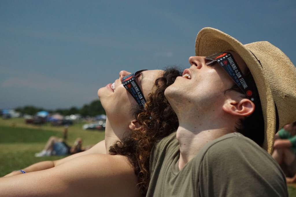 two festival goers observing the total solar eclipse in southern MO in 2017